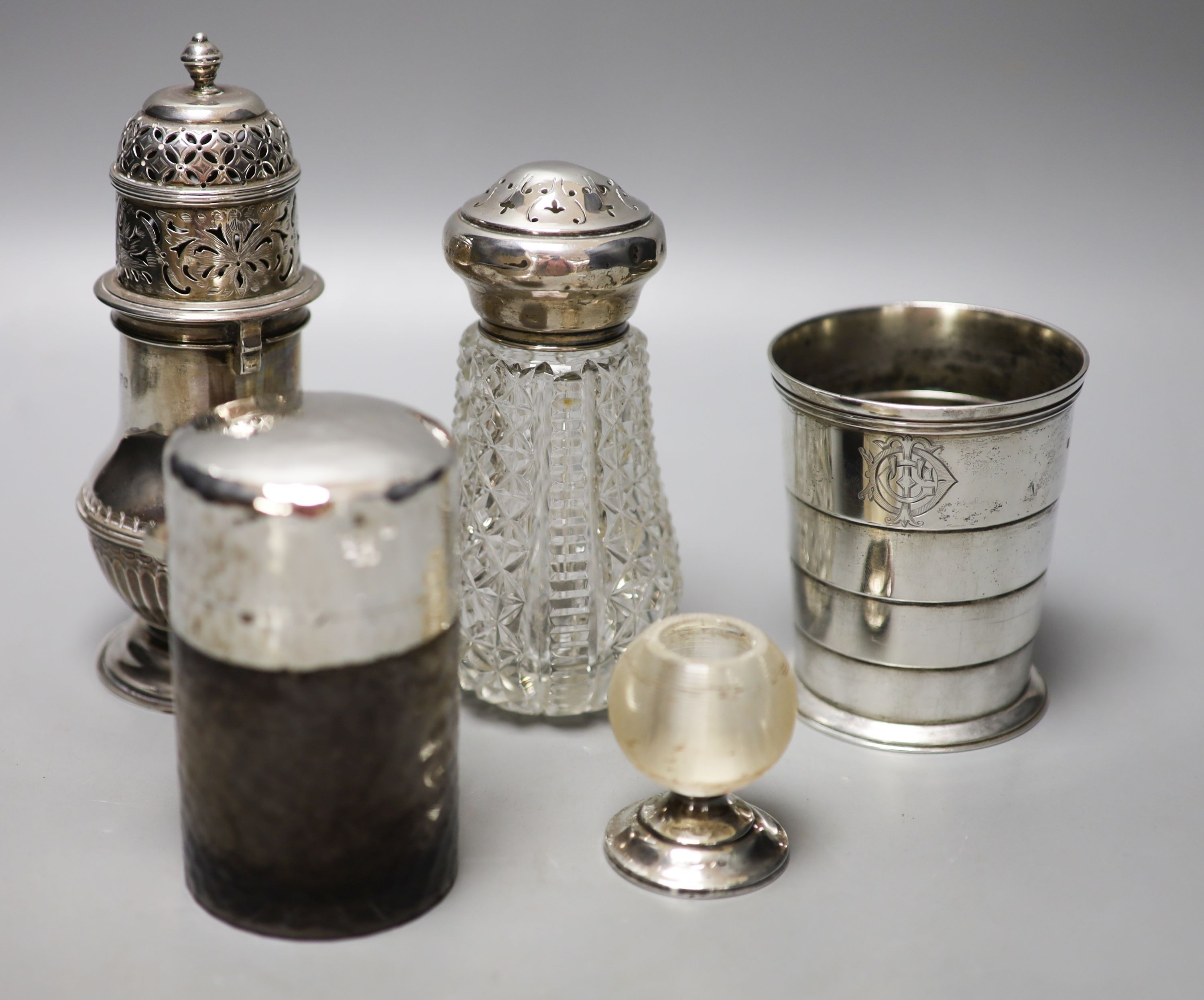 A Victorian silver travelling telescopic cup, Wright & Davis, London, 1881, 89mm, two sugar casters, a mounted glass tidy and a silver mounted salts bottle.